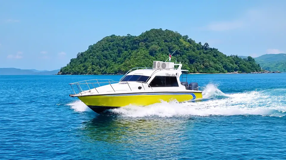 Fast passenger boat running across open blue water
